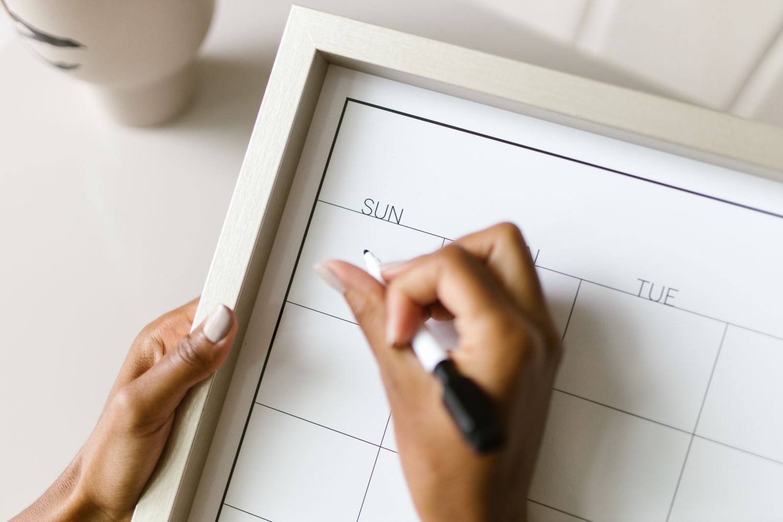Hand writing on a wall calendar while planning dates for short notice cruise deals