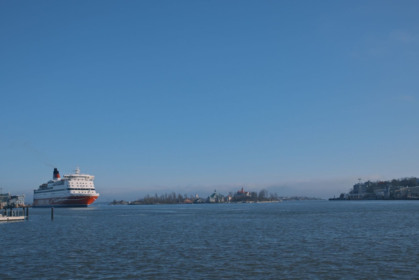 Short notice cruises: a cruise ship sailing toward an island under a clear blue sky