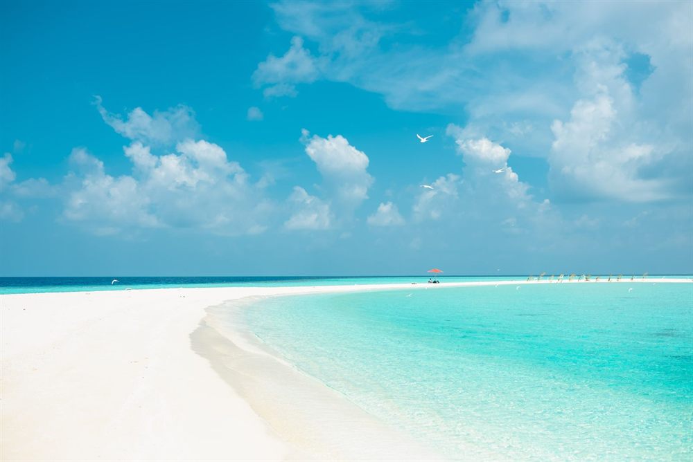 White sand beach and turquoise water under a bright sky